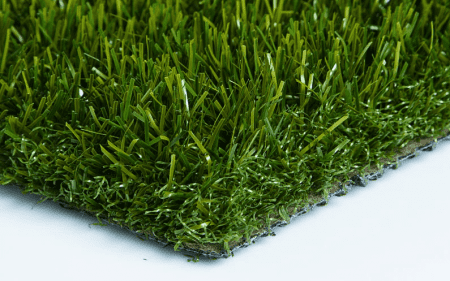 Close-up of artificial green grass blades on a turf mat.