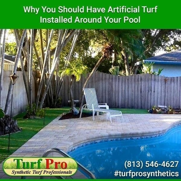 Artificial turf installed around a backyard pool with patio furniture and landscaping.