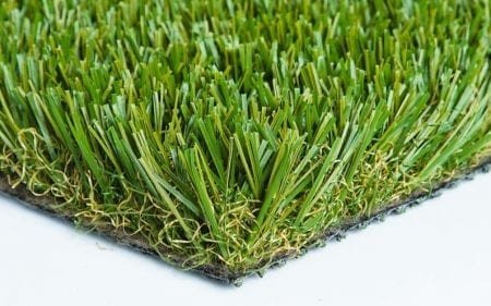 Close-up of synthetic grass blades on a turf piece.