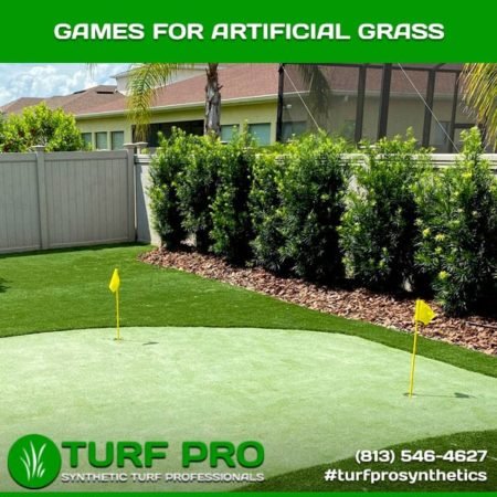 Artificial grass putting green in a backyard with flags and landscaping.