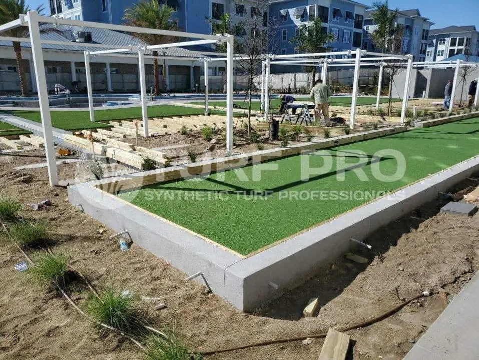 Miniature golf course putting green under construction outdoors.