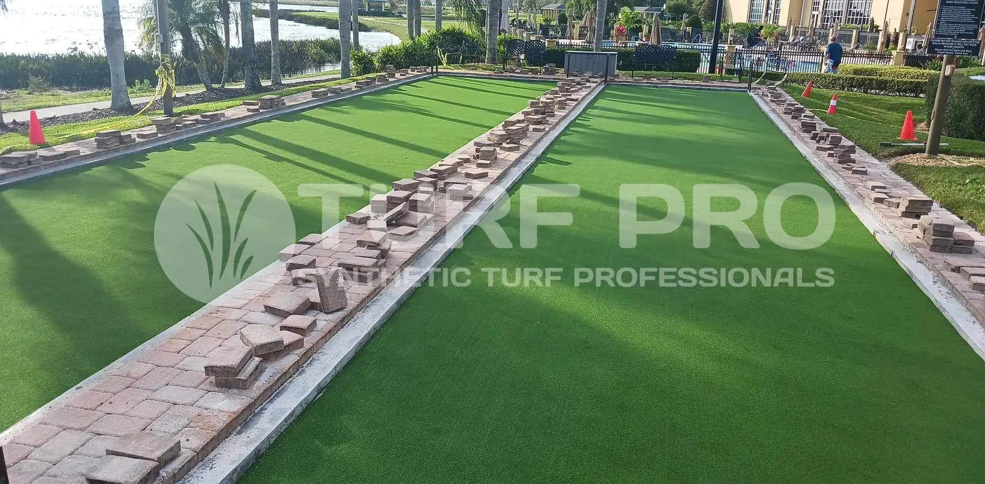 Artificial turf installation in progress with materials laid out on the side.