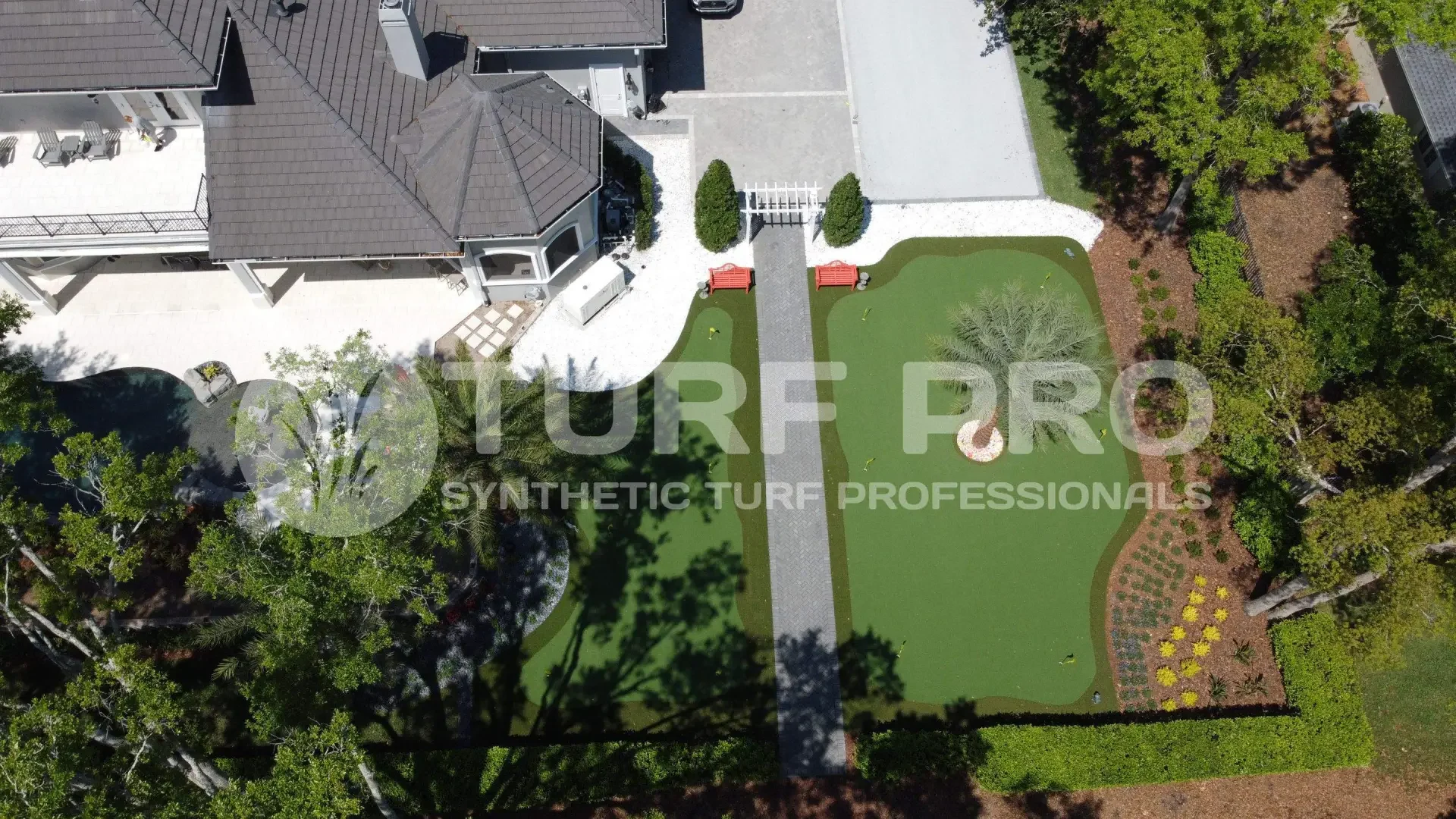 A backyard with synthetic turf and a shaded patio area.