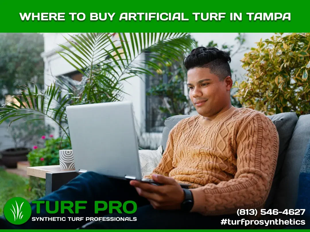 Man working on laptop promoting artificial turf in Tamil Nadu.
